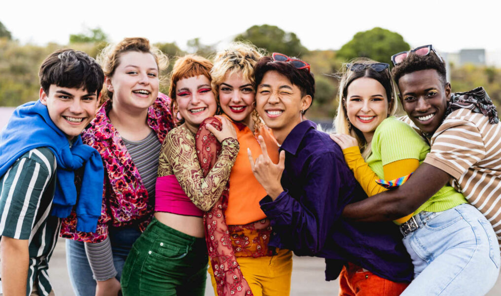 Diverse group of young people smiling and embracing